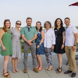 7 people, Maince Cancer Foundation staff, smile as they stand outside