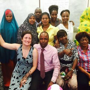 A group of people gather together and smile at the camera