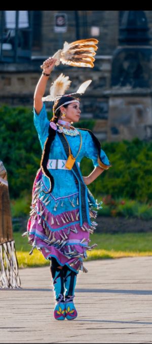 Sarah Decontie performs a jingle dance outside